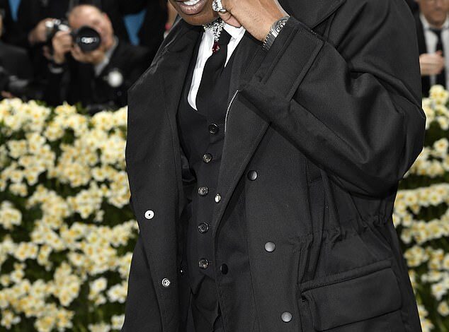 A$AP Rocky Faces Criticism as Fans Detect Ominous Detail in Met Gala Attire Following Gun Case Acquittal  
This title maintains the core elements of the original while using more formal synonyms ("Faces Criticism," "Detect," "Ominous," "Attire") and clarifies the legal outcome ("Acquittal") for precision.