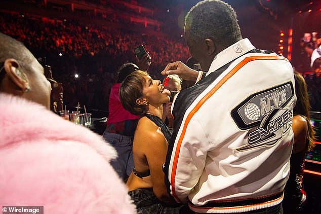 Title: Idris Elba and Wife Sabrina Share Steamy Cherry-Feeding Moment at Usher’s London Concert
This version retains the key details (steamy interaction, cherry-feeding, Usher’s concert, and location) while omitting ages and streamlining the language for clarity and conciseness. The adjective "wild" was excluded to avoid sensationalism, focusing instead on the central romantic gesture.