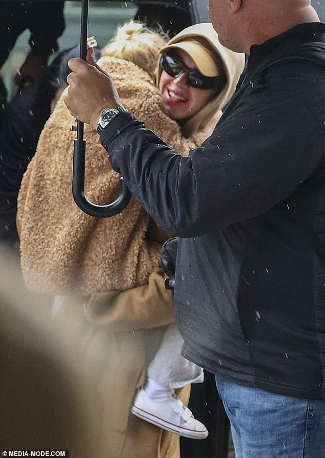 Katy Perry Holds Daughter Daisy Dove During Australia Departure in First Sighting Since Orlando Bloom Split  
(Note: Adjusted phrasing for conciseness and clarity while preserving key details.)