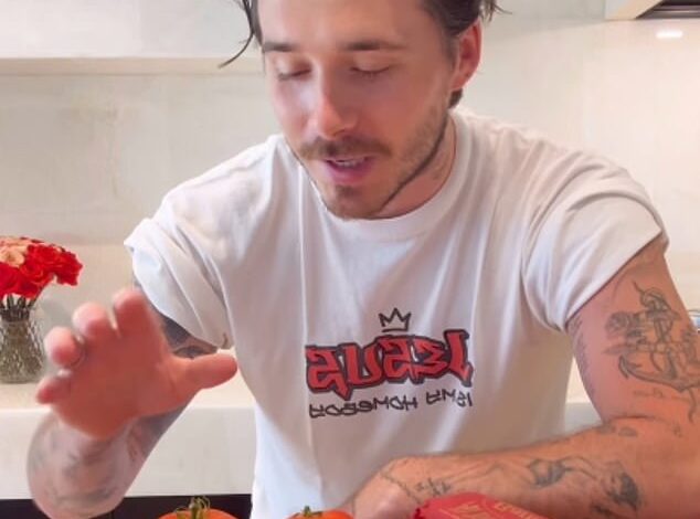 Title: Brooklyn Beckham Makes Cookery Comeback After Criticism from King Charles’ Former Chef, Prepares Pasta for Nicola Peltz in ’00s "Jesus Is My Homeboy" Shirt
