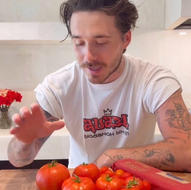 Title: Brooklyn Beckham Makes Cookery Comeback After Criticism from King Charles’ Former Chef, Prepares Pasta for Nicola Peltz in ’00s "Jesus Is My Homeboy" Shirt