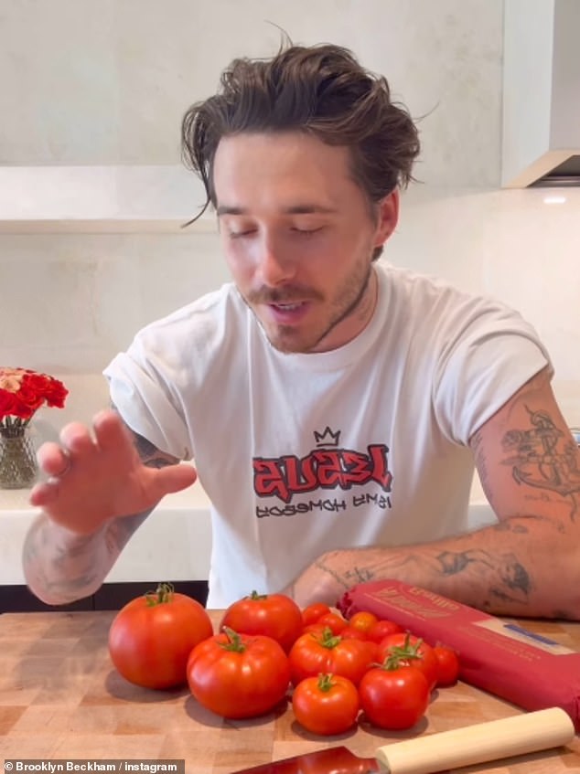 Title: Brooklyn Beckham Makes Cookery Comeback After Criticism from King Charles’ Former Chef, Prepares Pasta for Nicola Peltz in ’00s "Jesus Is My Homeboy" Shirt