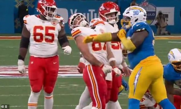 Title: Taylor Swift Fans Lash Out After Travis Kelce Is Violently Slapped at Football Game  
This version clarifies that Kelce was the recipient of the slap, maintains the original structure, and uses concise, headline-appropriate language.