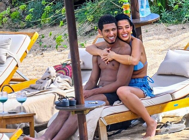 Title: "Jude Bellingham Shows PDA with Bikini-Clad Girlfriend Ashlyn Castro on Holiday as Injured England Star Misses Serbia Clash"  
This version maintains key details (PDA, Ashlyn Castro’s attire, Bellingham’s injury, and England’s match) while presenting the information neutrally and concisely.